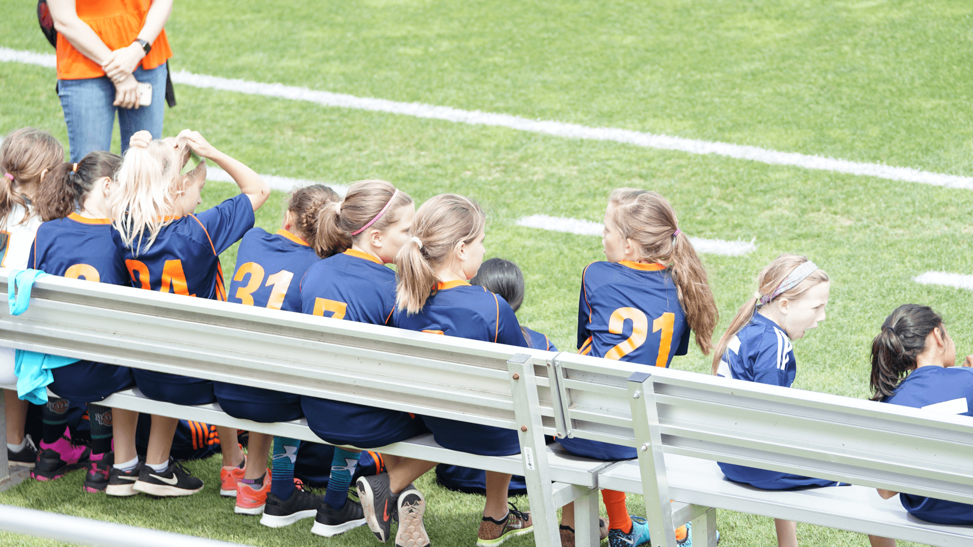 things to do at soccer tournaments, girls sitting on bench