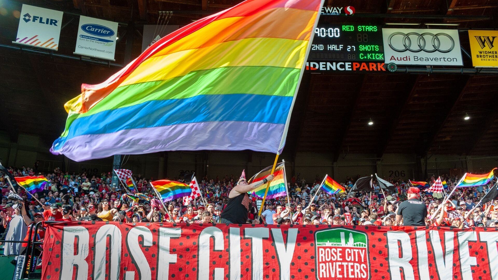 waving pride flag at providence park