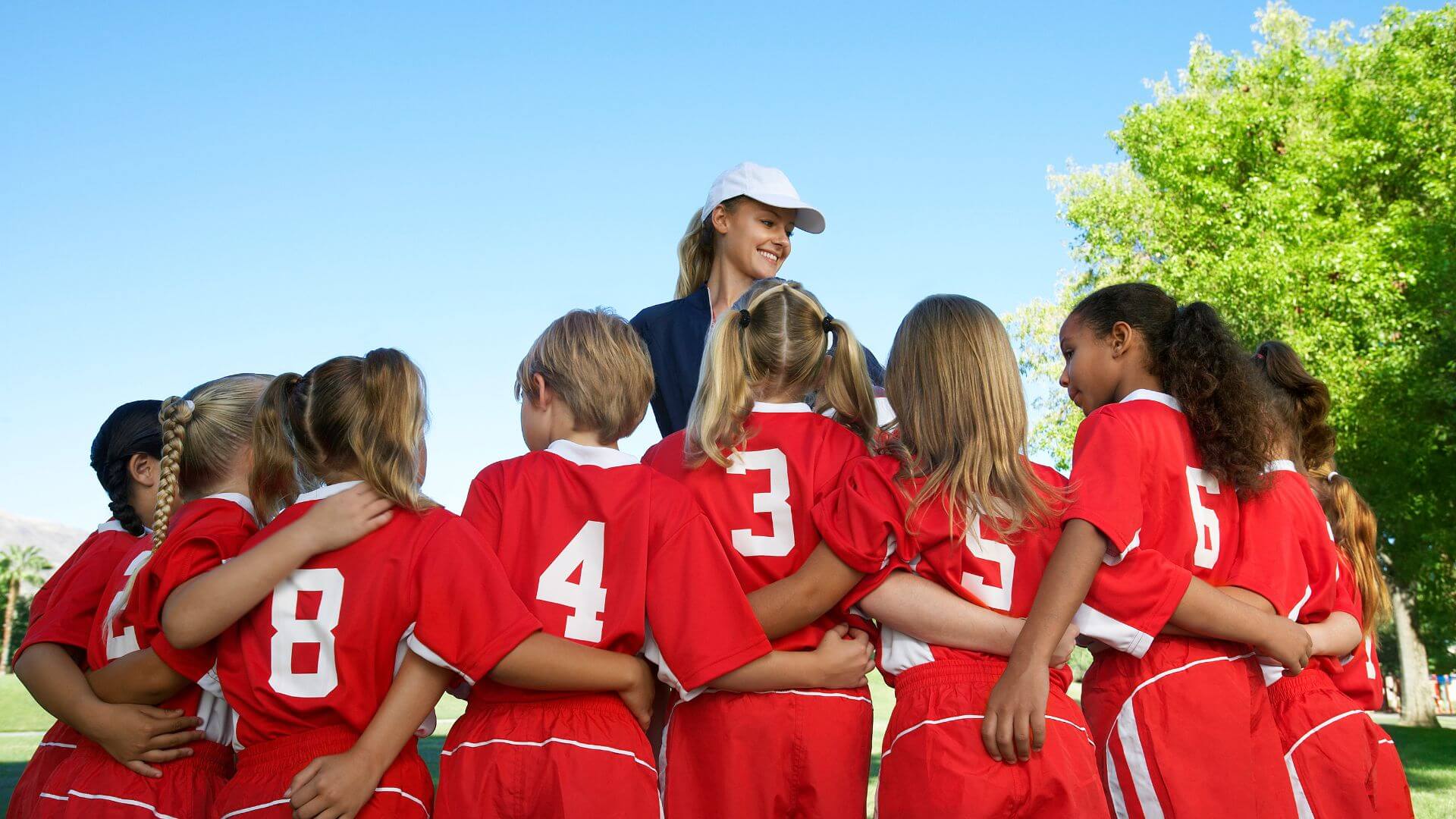 Girl volunteering to coach a little kids team