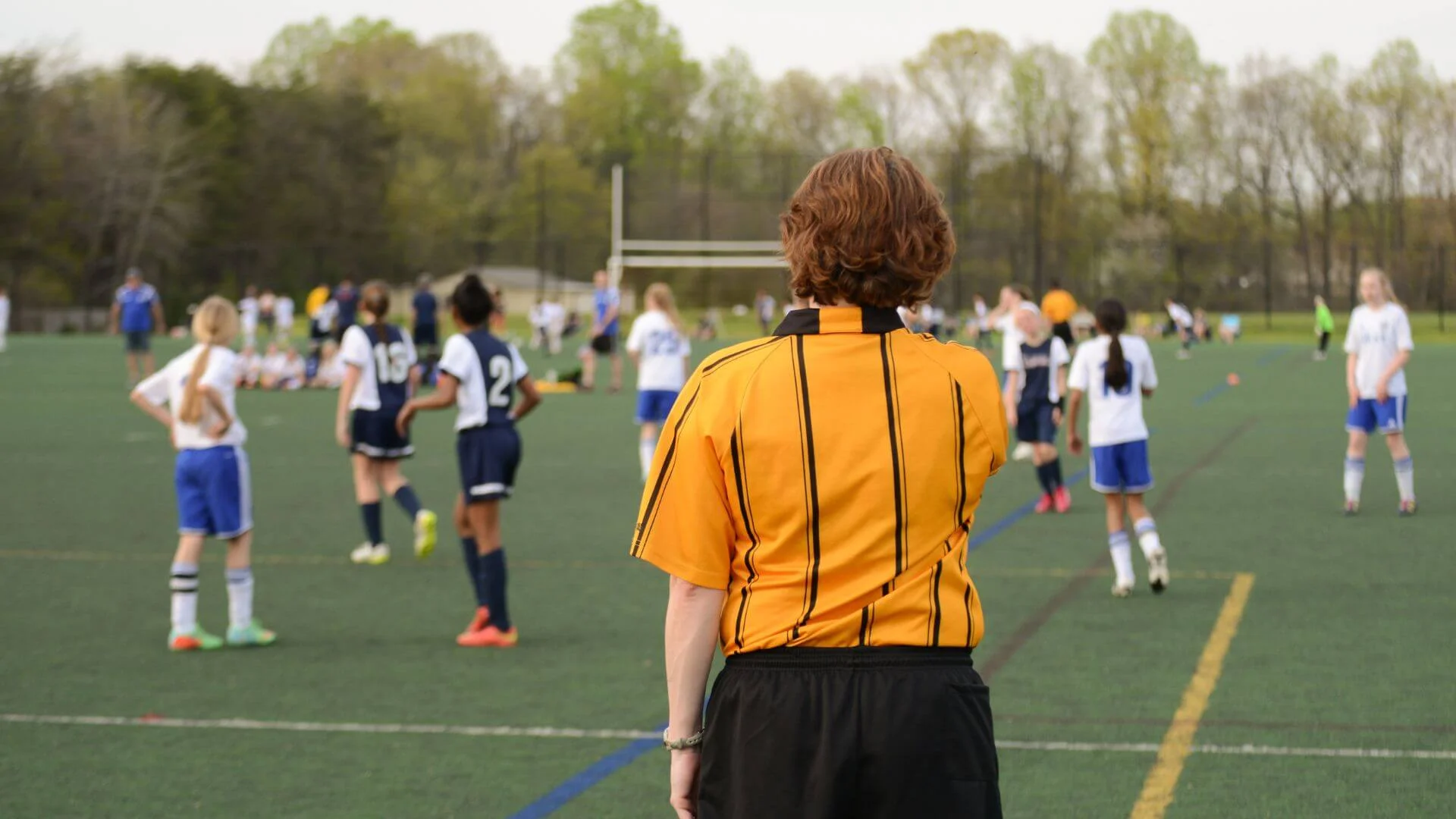 Referee officiating a girls soccer game